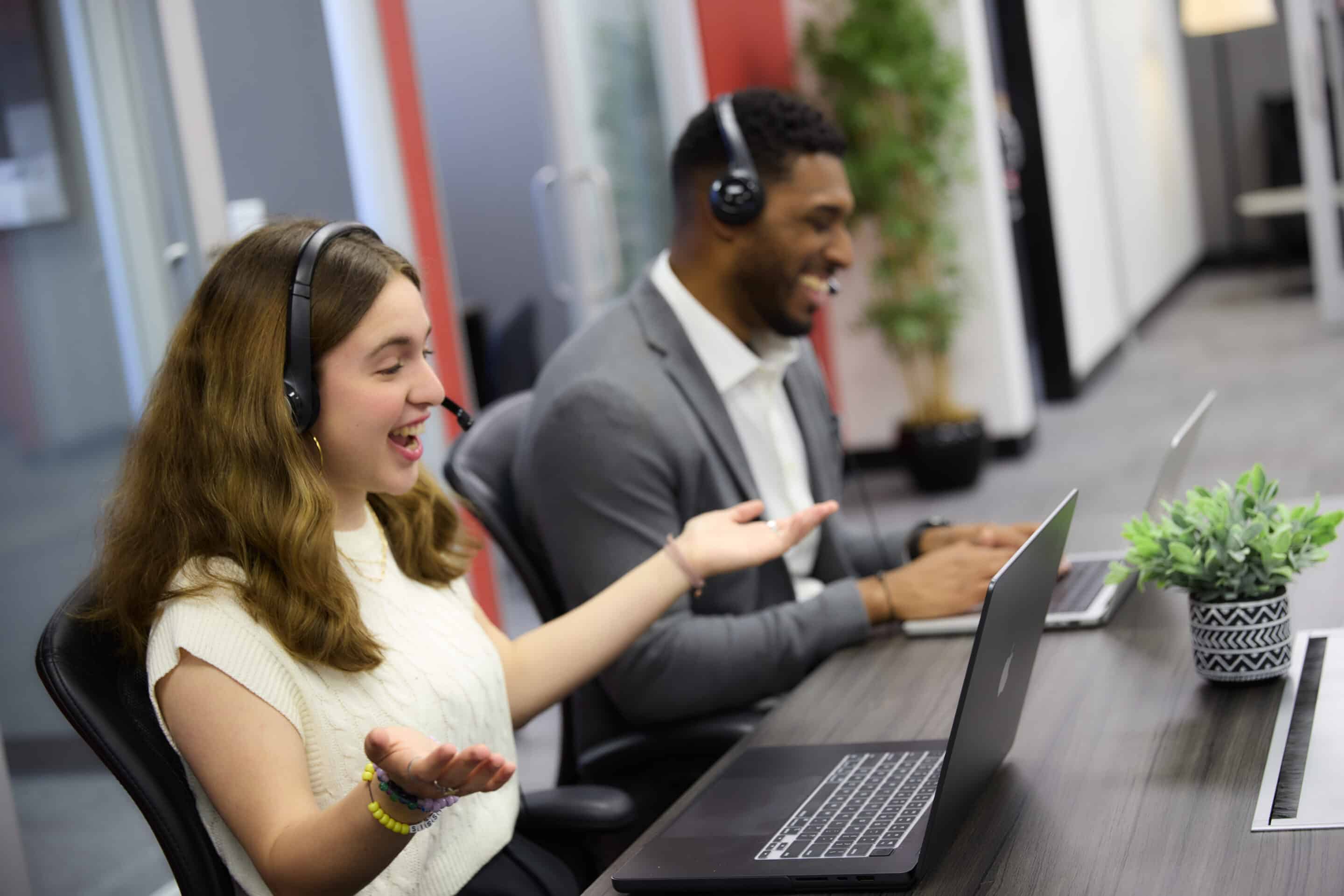 woman and man on call center taking calls smiling customer service jobs